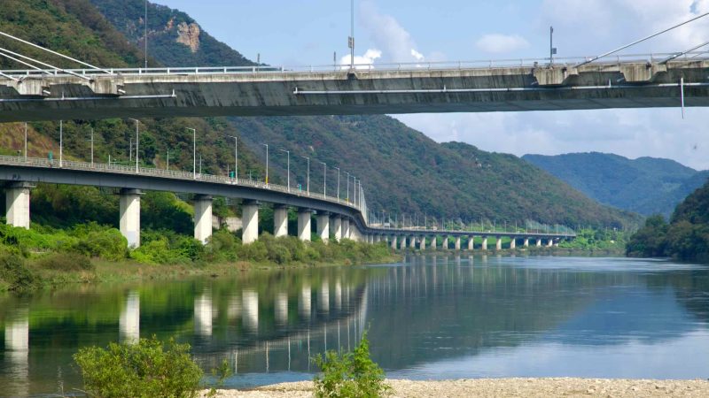 Twin viaducts follow the North Han River canyon below Gangchon Grand Bridge, their piers reflecting in calm water.