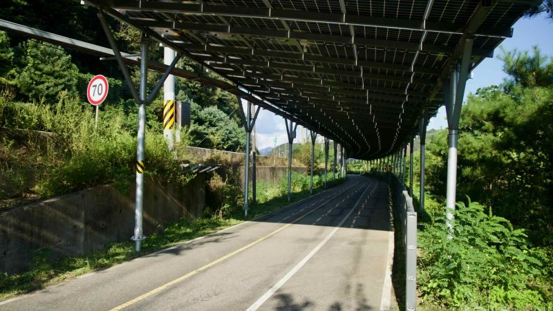 A long solar canopy shades the Bukhangang Bike Path beside Daljeon Stream in Gapyeong.