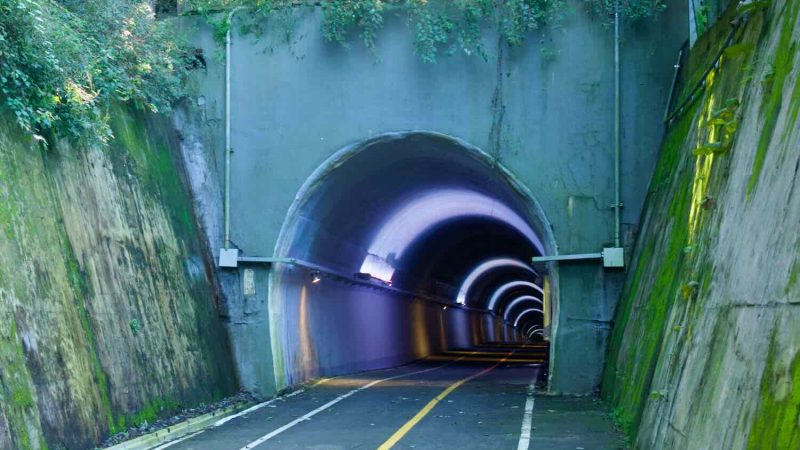 A closer look at the Saekhyeon Tunnel portal shows its rounded arch and interior lighting.