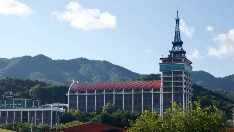 The Cafe Paris complex with its tower comes into view from the Bukhangang Bike Path in Sangcheon Village.