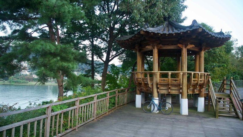 A wooden pavilion by pines stands over the Bukhangang in Namyangju.