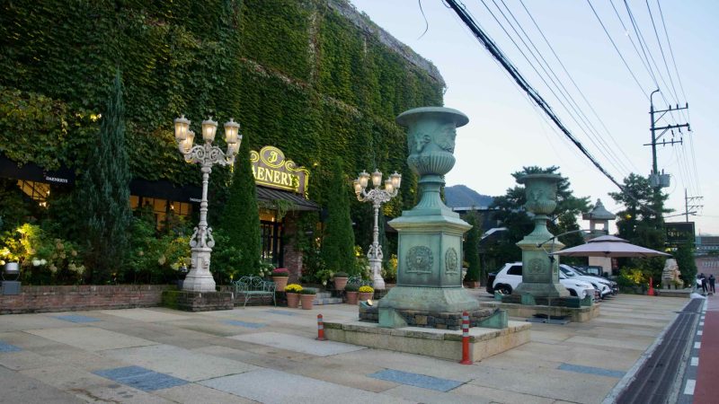 An ivy-clad restaurant front glows with lamps near the Bukhangang in Namyangju.