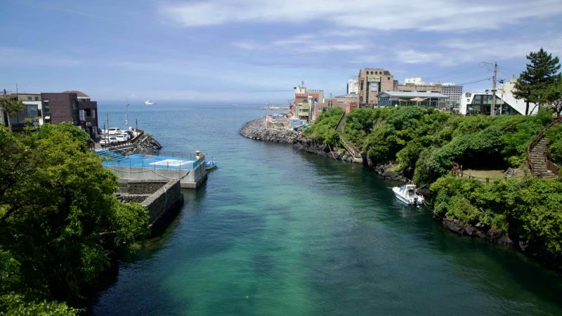Yongyeon Valley’s channel opens toward the sea between rocky headlands.