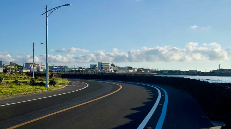 Hallimhaean‑ro curves along the seawall in Gwideok with a painted bike lane.