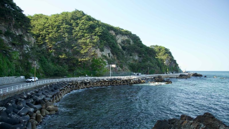 Gangneung City, South Korea - May 18, 2024: Heonhwa Road runs along the East Sea with concrete wave breakers lining the coast…