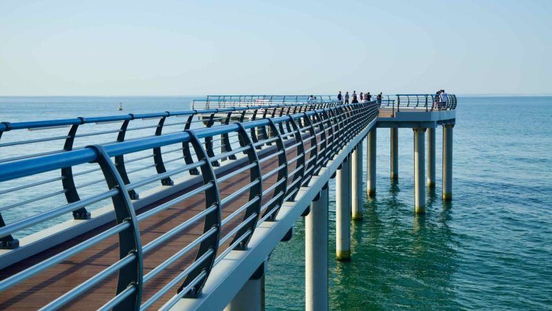 Visitors along the observation deck near Sun Cruise Resort in Jeongdongjin, overlooking the serene East Sea waters.
