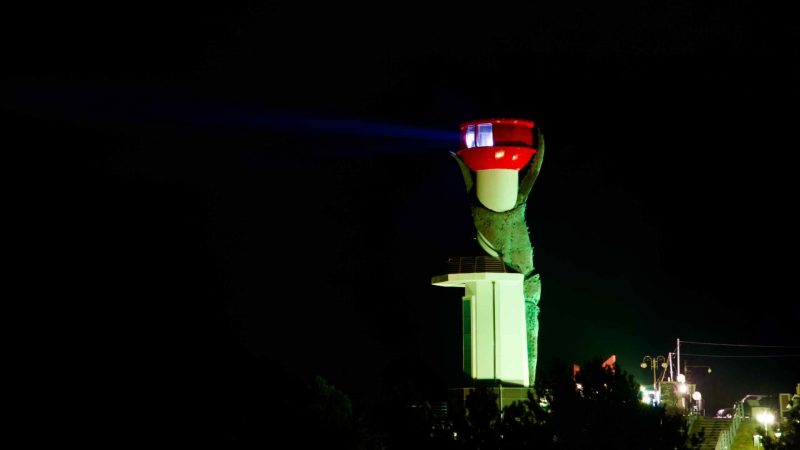 The Changpomal Lighthouse emerges boldly against a pitch-black sky, a solitary beacon of light on the Yeongdeok coastline.