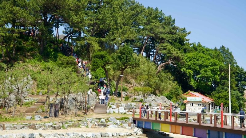 Tourists make their way up the scenic stairs to Chuam Candlestick Rock.