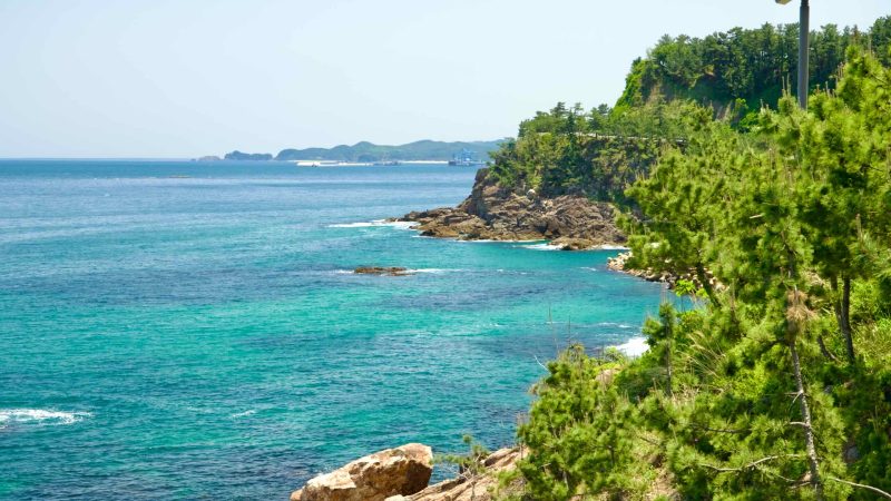 A view from Beach Sculpture Park, looking southward along the rocky coastline on Isabu Road.