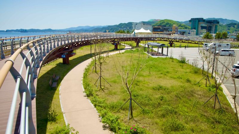 Samcheok City, South Korea - May 18th, 2024: An elevated view of the walkway and green space at Isabu Plaza. The curved pedes…