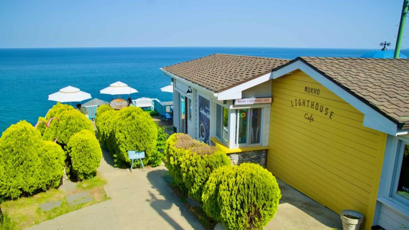 The Mukho Lighthouse Cafe, situated below Mukho Lighthouse, offers visitors a serene spot to enjoy coffee with views of the East Sea.