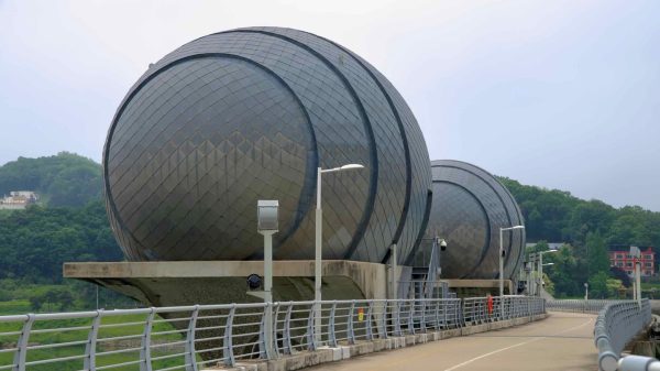 Cyclists pass under the futuristic, egg-shaped control towers of Ipo Weir, which regulate South Han River.