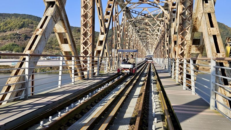 A picture of rail bikes on Sinnakdong Steel Bridge (신낙동강철교) over the Nakdong River (낙동강) between Gimhae and Miryang Cities, South Korea.