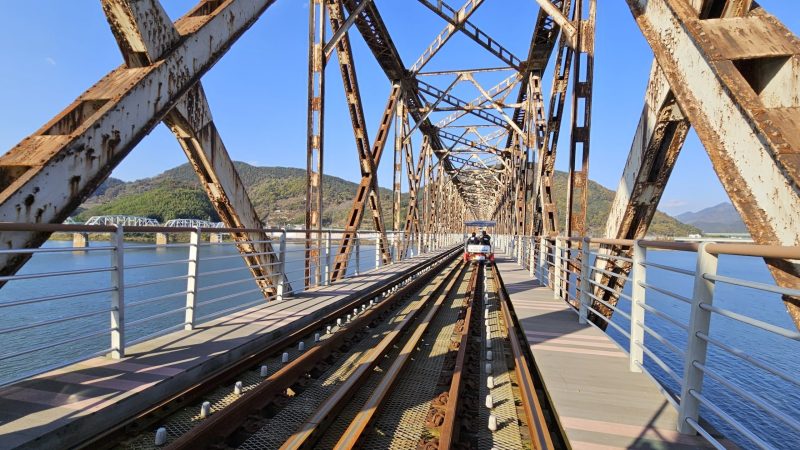A picture of rail bikes on Sinnakdong Steel Bridge (신낙동강철교) over the Nakdong River (낙동강) between Gimhae and Miryang Cities, South Korea.