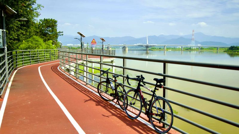 A picture of a raised cycling path that leads to Gangjeong Goryeong Weir (강정고령보) along the Nakdong River in Daegu, South Korea.