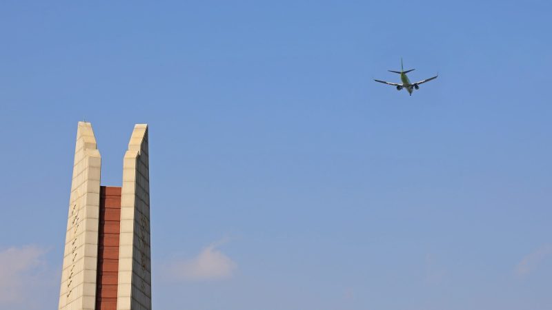 A picture of an passenger jet landing at Gimhae International Airport from the finish line of the Nakdonggang Bike Path.
