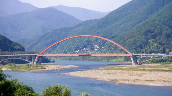 Namdo Bridge, with its red and blue arches, stretches across the Seomjin River.