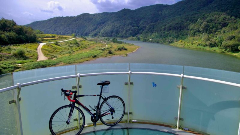 A road bike rests on the glass-bottom Skywalk of Hyangga Bridge.