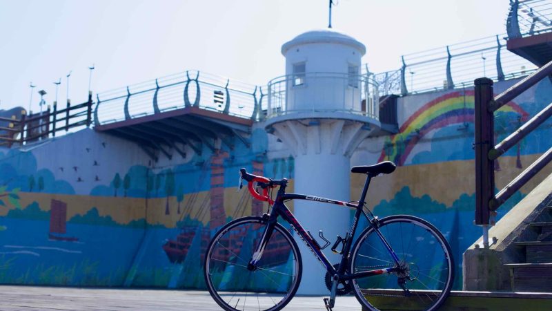 A bike leans against wooden stairs at the Yeongsanpo Floodgate.